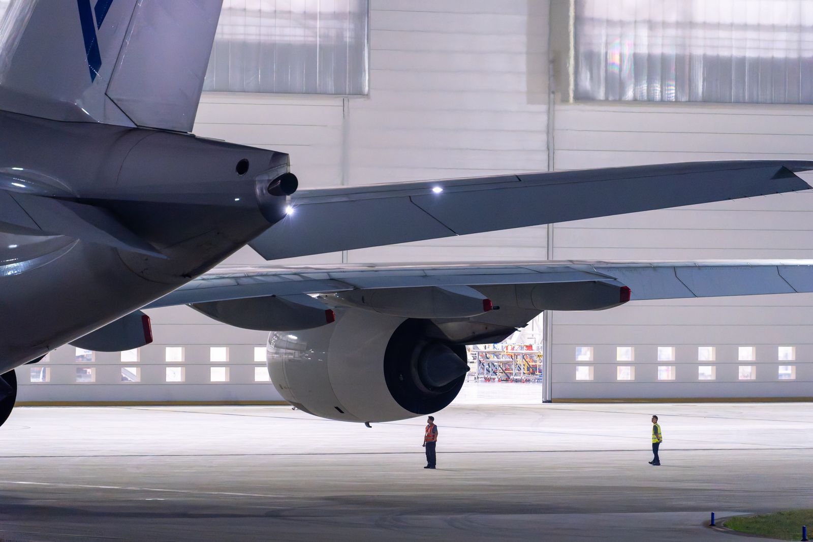 Maintenance crew working on a widebody aircraft in a hangar